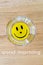Vita smiley face on an ashtrayon wood background with text