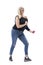 Vital energetic active middle aged attractive woman dancing carefree in casual clothes.
