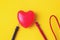 Vital energy concept. Red heart with multimeter probes on a yellow background. Love, technology concept. Happy Valentine s Day.