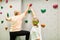 Vital senior woman climbing a climbing wall