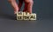 Vital vs lethal symbol. Businessman turns wooden cubes and changes the word `lethal` to `vital`. Beautiful grey background, co