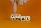 Vital vs lethal symbol. Businessman turns wooden cubes and changes the word `lethal` to `vital`. Beautiful orange background,