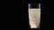 Vitamin C tablet dissolving in a glass of fresh mineral still water on dark backdrop. Bubbling pill in liquid with oxygen balls on