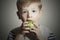 Vitamin.Child eating apple.Little Boy with green apple. Health food. Fruits
