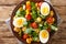 Vitamin delicious salad of lupine beans, boiled eggs, tomatoes and common cornsalad close-up in a plate. horizontal top view