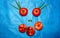 Vitamin face of tomatoes, flat nectarines and green onions on a blue background