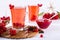 Vitamin healthy viburnum berry warm drink in glass cups with fresh raw viburnum berries