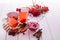 Vitamin healthy viburnum berry warm drink in glass cups with fresh raw viburnum berries and cinnamon sticks, anise stars