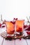 Vitamin healthy viburnum berry warm drink in glass cups with fresh raw viburnum berries and cinnamon sticks, anise stars