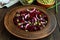 Vitamin salad of beets, green peas, blue onion in a clay bowl.