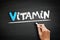 Vitamin text on blackboard, health concept background