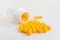 Vitamins. Antiviral drug tablets. Round yellow healthy pills and pill bottle on white background