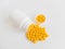 Vitamins. Antiviral drug tablets. Round yellow healthy pills and pill bottle on white background