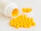 Vitamins. Antiviral drug tablets. Round yellow healthy pills and pill bottle on white background