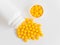 Vitamins. Antiviral drug tablets. Round yellow healthy pills and pill bottle on white background