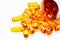 Vitamins, dietary supplement the Omega 3 cod-liver oil poured out from banks close up on a light background