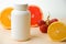 Vitamins. White empty bottle for vitamins on a background of citrus fruit slices. lemon. orange. White background. Blank Medicine