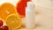 Vitamins. White empty bottle for vitamins on a background of citrus fruit slices. lemon. orange. White background. Blank Medicine