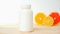 Vitamins. White empty bottle for vitamins on a background of citrus fruit slices. lemon. orange. White background. Blank Medicine