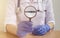 Vitamins word through magnifying glass in doctor hand in gloves. health concept