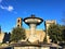 Vitorchiano town fountain and ancient buildings, Italy. Art and the sky