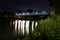 Vittoria bridge in San Dona di Piave illuminated in the evening with reflection on the Piave river