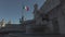 Vittoriano s fountain and white marble decoration and Italian flag in blue sky