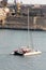 Vittoriosa, Malta, July 2016. Catamaran with tourists on the background of the fortress walls of the ancient city.