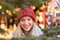 Vivacious happy young woman at a Christmas market