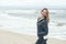 Vivacious laughing carefree woman on a windswept beach