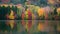 Vivid autumn hues envelop a serene lake nestled in woods