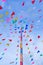 Vivid color of Thai`s style fancy party flag strips decoration on a fancy still pole with blue sky and white cloud in background