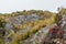 Vivid colors of the autumn trees on a rocky cliff in a canyon of Gradasnicka river, Pirot, Serbia.