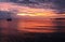 Vivid crimson clouds and sky sunrise seascape with water reflect