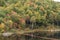 Vivid foliage covering hillside at Otter Brook Dam in southern New Hampshire