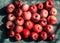 Vivid freshly picked red apples with contrasting shadows on the metal table