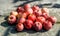 Vivid freshly picked red apples with contrasting shadows on the old metal table