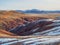 Vivid multicolor nature background of colorful highland valley among big rocky mountains. Snow surface of giant red mountain rough