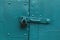 Vivid old aquamarine metallic locked door texture background. Door with old metal lock