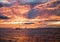 Vivid Orange Sunset Reflecting in Ocean Surface wtih Sailboat on