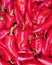 Vivid red horn organic  peppers top view closeup