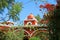 Vivid red and white dome of vintage Peruvian building against sunny clear sky, Huacachina oasis town, Ica region, Peru