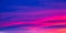 Vivid saturated beautiful sunset sky in pink, purple and blue colors. Abstract amazing sunset background