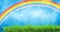 Vivid spring landscape with rainbow and green grass