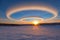 vivid sun dogs above arctic tundra at sunset
