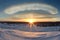 vivid sun dogs above arctic tundra at sunset