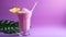 Vivid tropical pink slushy on a purple background, a refreshing summer drink with a chilled and fruity vibe, perfect for vacation