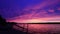 Vivid ultra violet sunset over calm water at Silver Lake, NY State