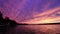 Vivid ultra violet sunset over calm water at Silver Lake, NY State