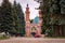 Vladikavkaz, Russia - 07 18 2019: People having rest on the square among beautiful old pine trees in front of Sunni